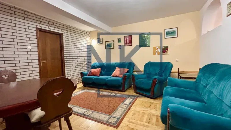 Spacious living room with a seating set and a dining table.