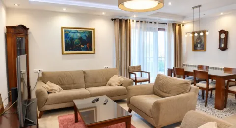 Living room with a sofa set, coffee table, and dining area in the background. - image 4