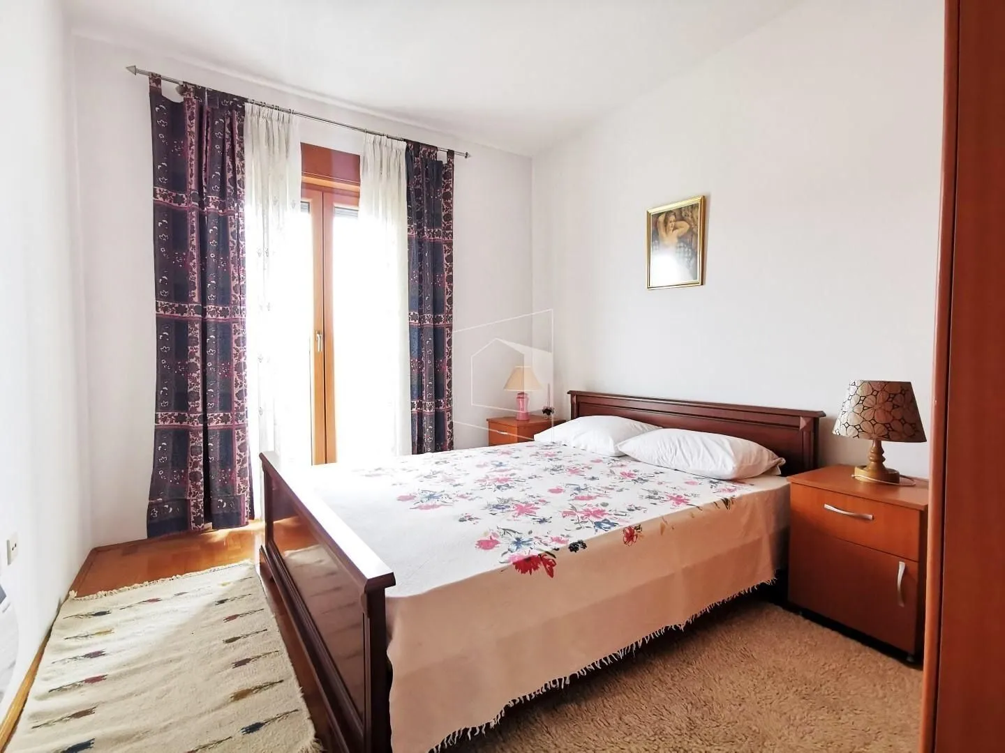 Bright bedroom with a double bed and nightstands.