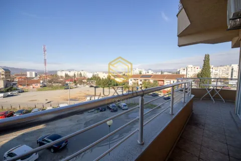Spacious balcony with a view of the surrounding neighborhood and parking area. - image 11