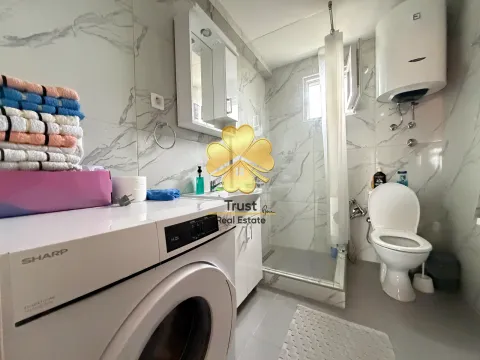 Modernly equipped bathroom with washing machine and shower cabin. - image 8