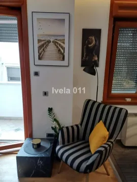A comfortable armchair with a small table and decorative details in the living room. - image 3