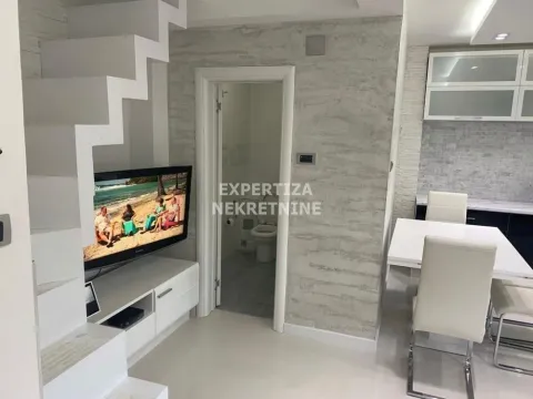 Living room with dining area, staircase, and a view of the bathroom. - image 5