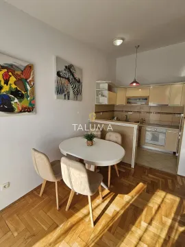 Smaller kitchen with a dining table and parquet flooring. - image 5