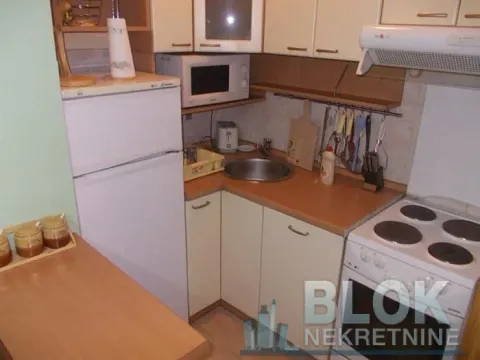 Smaller kitchen with a refrigerator, stove, and sink. - image 9
