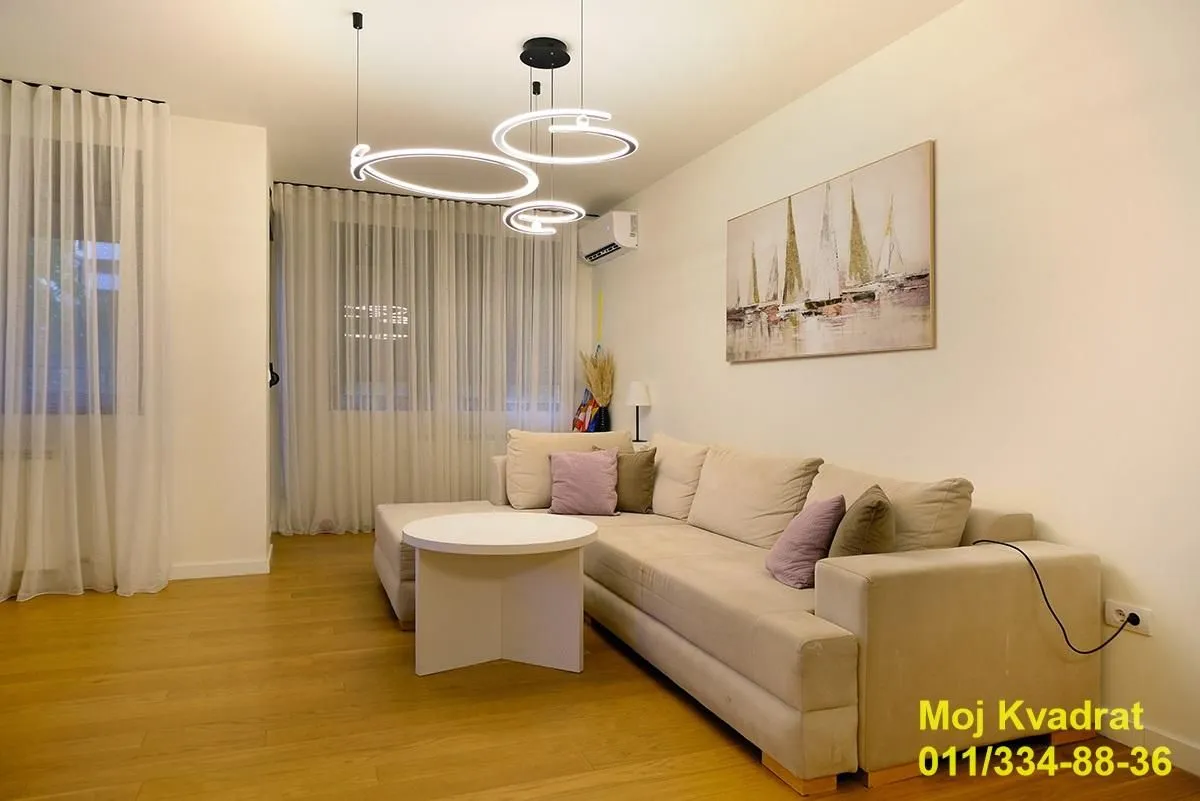 Living room with a comfortable sofa, coffee table and modern lighting.