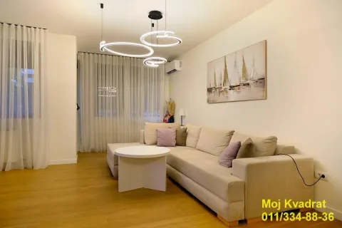 Living room with a comfortable sofa, coffee table and modern lighting. - image 4