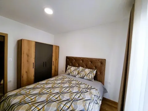 Furnished bedroom with a double bed and a wooden wardrobe. - image 7