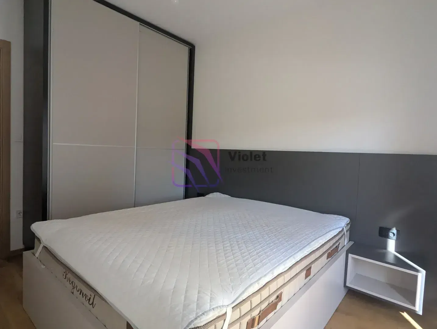 Bedroom with a double bed, wardrobe and a nightstand.