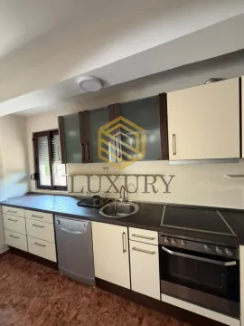 Small kitchen with cabinets and built-in appliances. - image 4