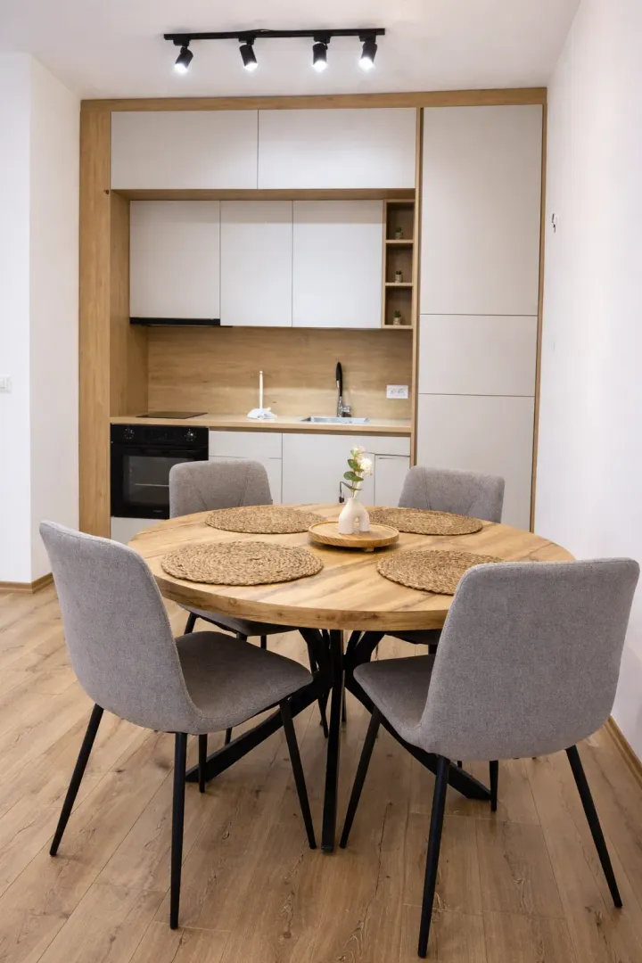 Modern kitchen with a dining table and grey chairs.