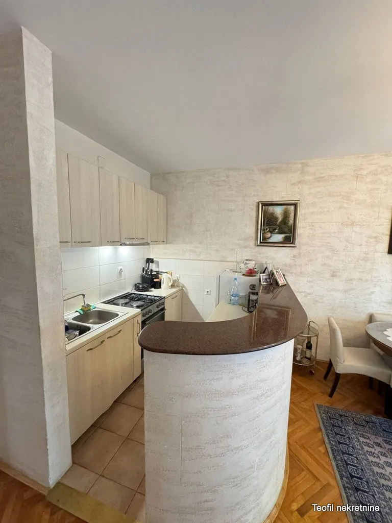Smaller kitchen with a breakfast bar and dining table.