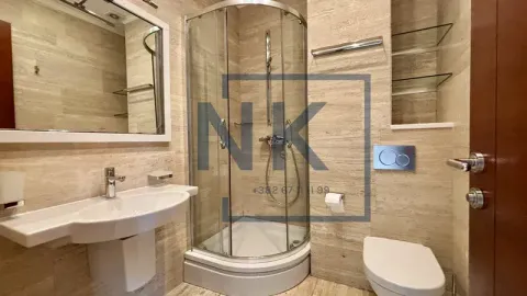 Bathroom equipped with a shower cabin, washbasin, toilet bowl, and mirror. - image 17