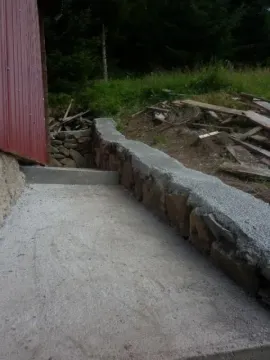 Betonska staza i kameni potporni zid pored objekta. - image 4