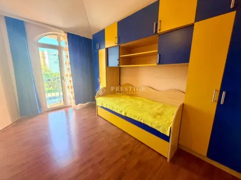 Children's bedroom with a bed and blue and yellow built-in wardrobes. - image 14