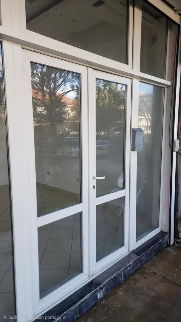 Entrance door and storefront with glass surfaces.
