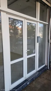 Entrance door and storefront with glass surfaces. - image 3