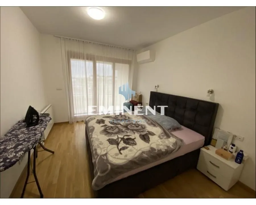 Bedroom with a double bed, bedside table, and access to the terrace.