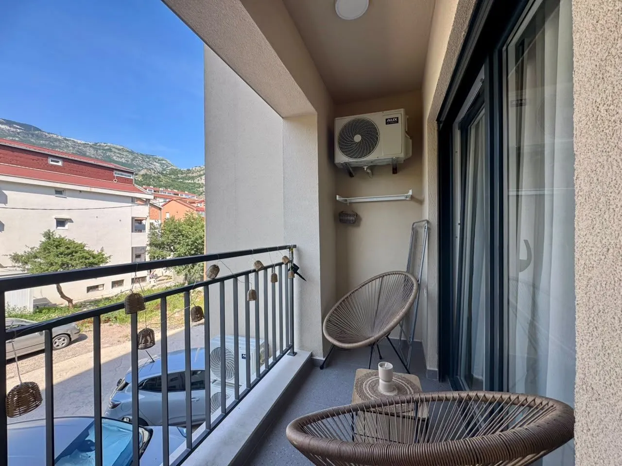 Furnished balcony with chairs and a view of the surroundings.