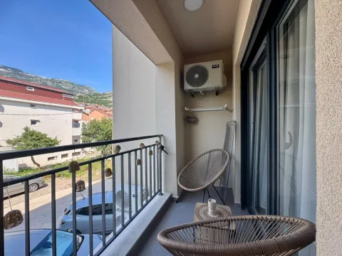 Furnished balcony with chairs and a view of the surroundings. - image 3