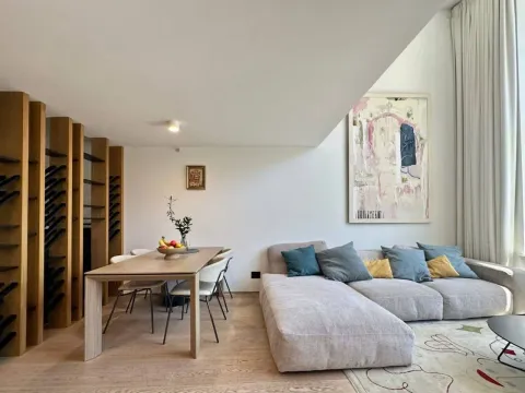 Living room with dining area, sofa set, and wooden shelving. - image 2