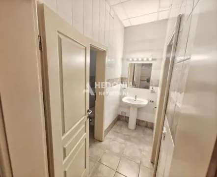 View of the bathroom with a sink, mirror and open door. - image 13