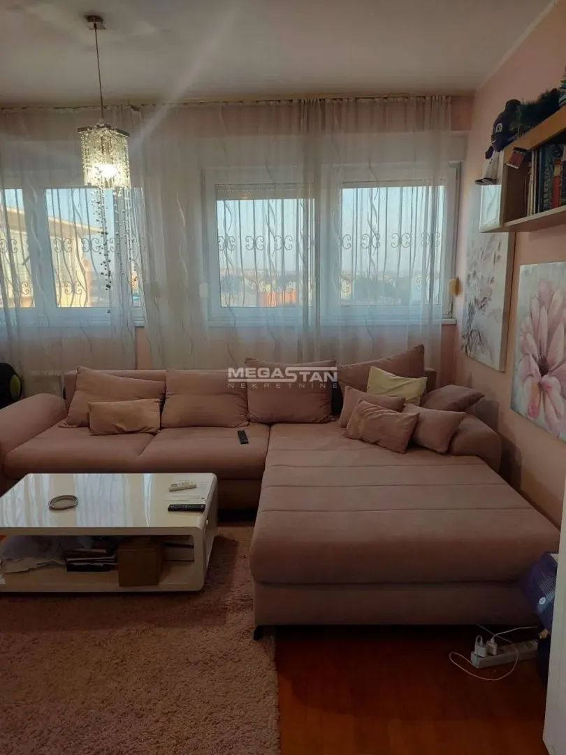 Living room with a sectional sofa and a white coffee table.