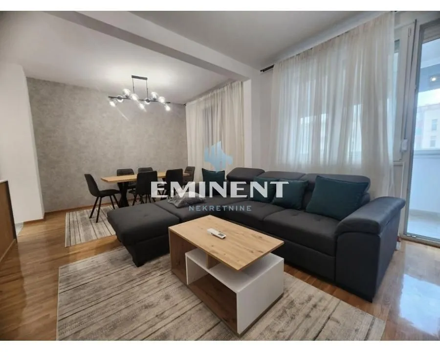 Spacious living room with sofa set and dining area.