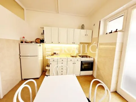 Kitchen with white cabinetry and a dining table. - image 3