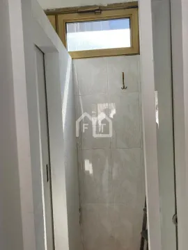 View of a small bathroom tiled with ceramic tiles. - image 6