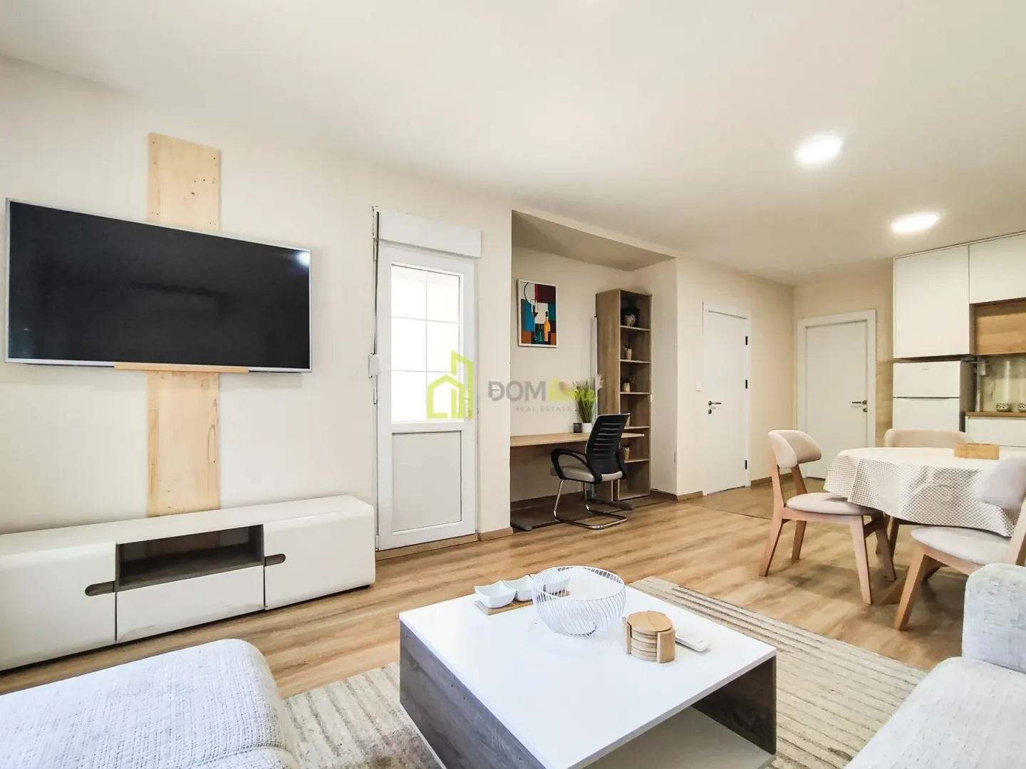 Living room with dining area and TV unit.