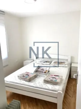 Furnished bedroom with a white bed and bedside tables. - image 4