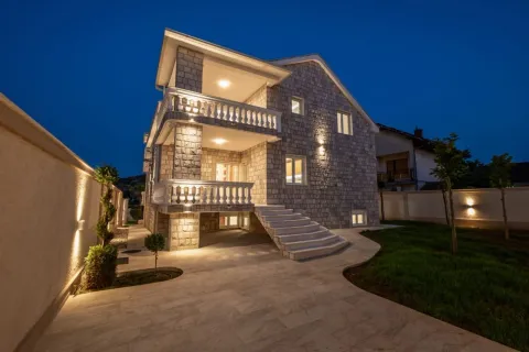Exterior view of the house with illuminated facade, terraces and yard at night. - image 13