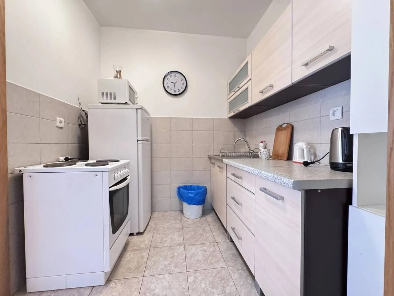 Smaller kitchen equipped with basic elements and appliances.