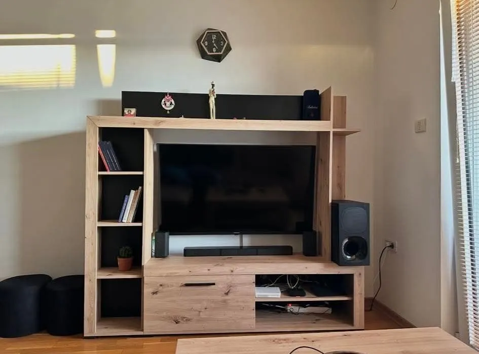 Living room with a TV unit and bookshelves.