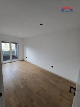 Empty room with wooden flooring and access to the balcony. - image 7