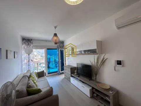 Furnished living room with sofa, TV unit, and access to the terrace. - image 4