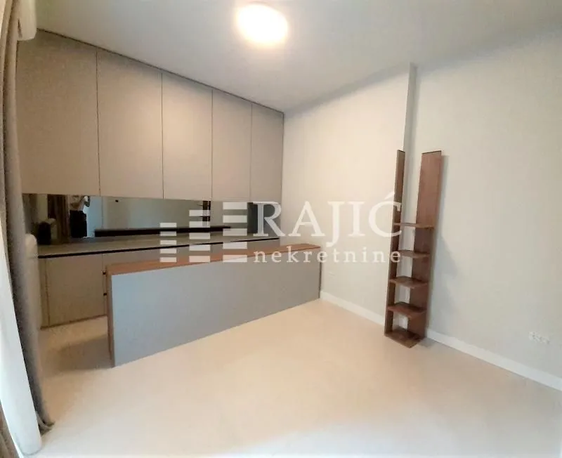 Living room with built-in cabinetry and shelving.