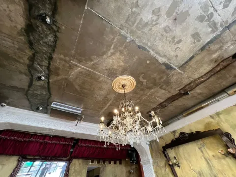 View of the ceiling with a rustic chandelier and decorative elements. - image 13