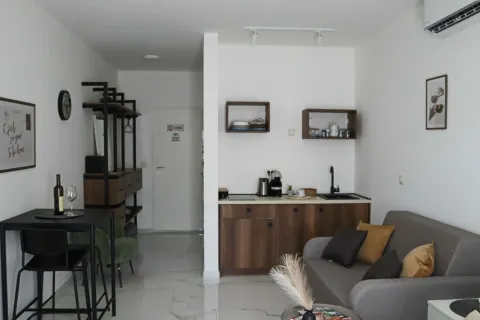Modern living room with a kitchen and a dining table. - image 4