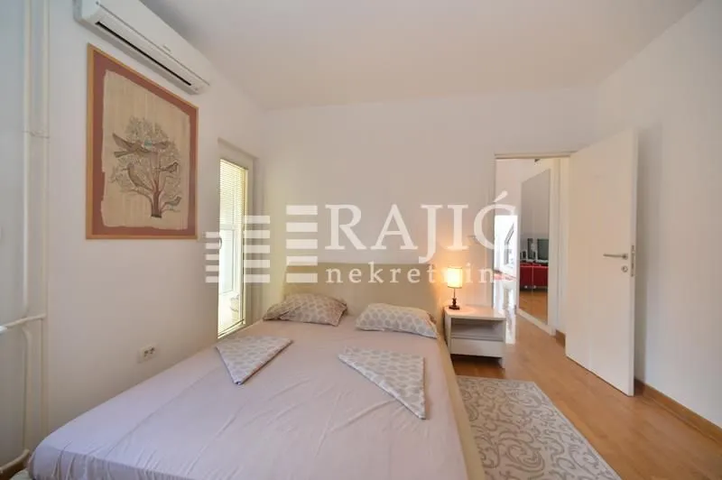 Furnished bedroom with a double bed and air conditioning.