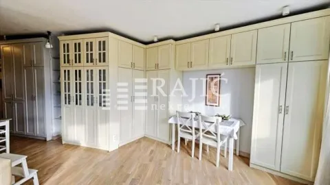 Living room with built-in wardrobes and a dining table. - image 5