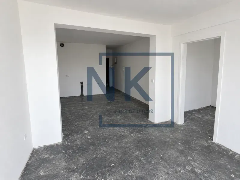 Empty room in an apartment during renovation with white walls.