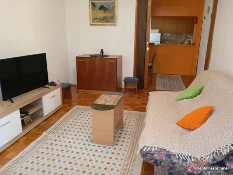 Living room with sofa, TV and a view of the kitchen. - image 13
