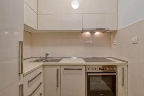 Kitchen with built-in cabinetry, sink, and oven. - image 11