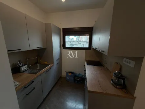 Small kitchen with grey cabinets and a wooden countertop. - image 3