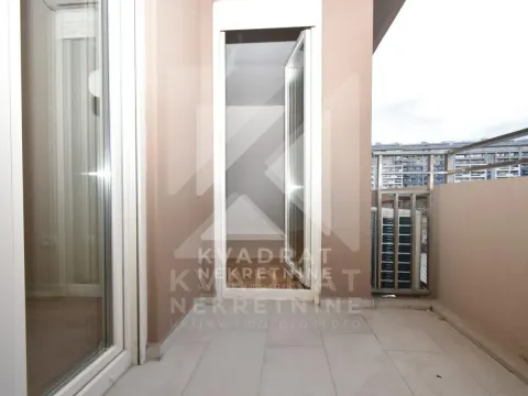 Small balcony with balcony doors and a view of surrounding buildings. - image 14