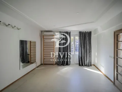 Empty room with a wall mirror, doors leading to a terrace, and a large window. - image 14