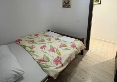 Smaller bedroom with a double bed and light laminate flooring. - image 4