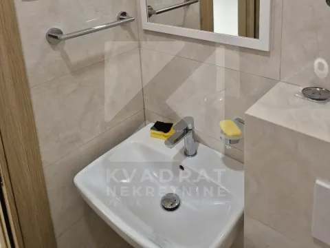 Bathroom detail featuring a washbasin and a mirror. - image 6